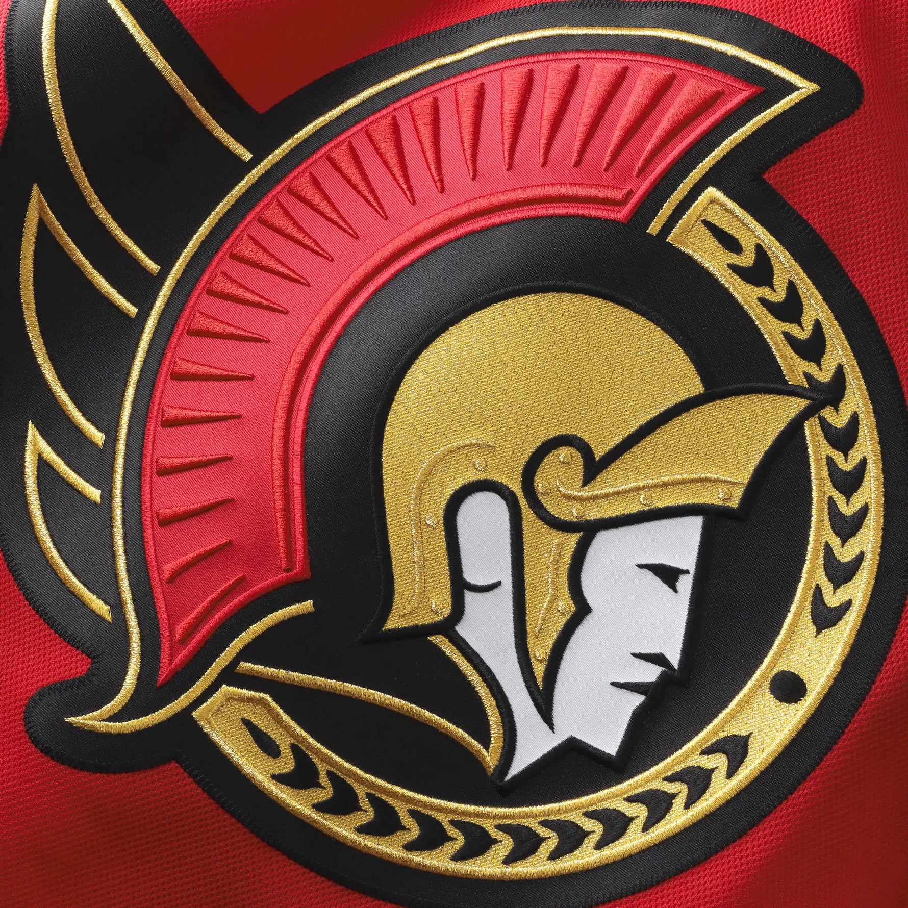 Close-up of a Ottawa Senators Alternate Jersey team logo with a helmeted figure on a red background